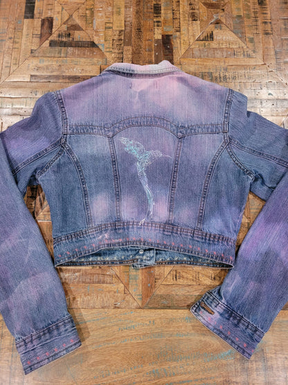 a blue and purple denim jacket on a wooden table.