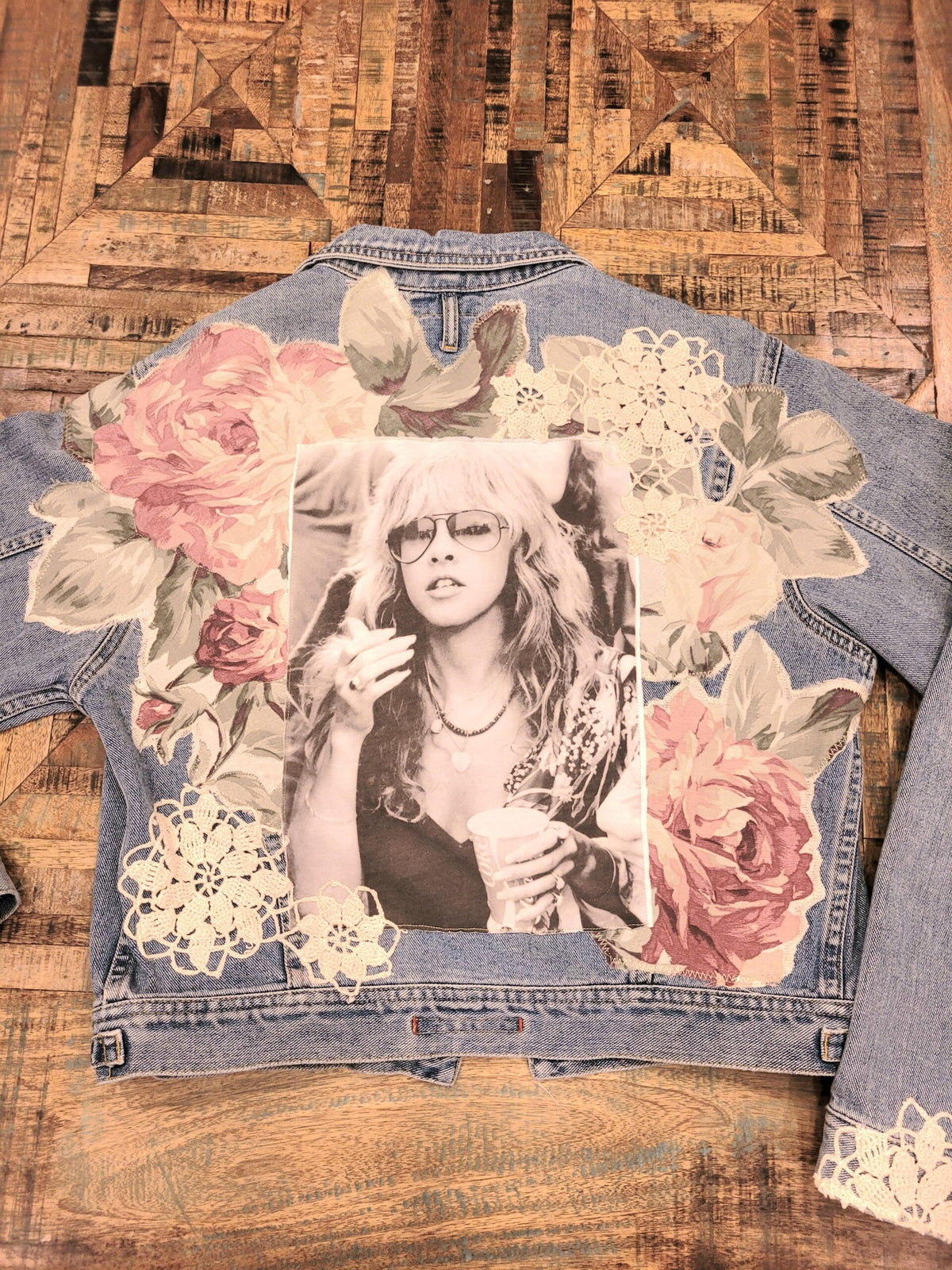 A denim jacket with a photo of a woman on it.