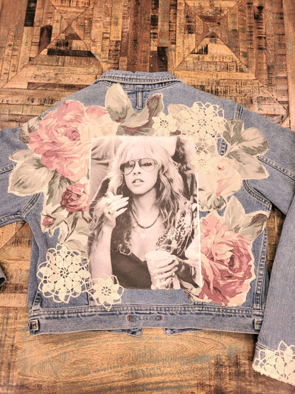 A denim jacket with a photo of a woman on it.