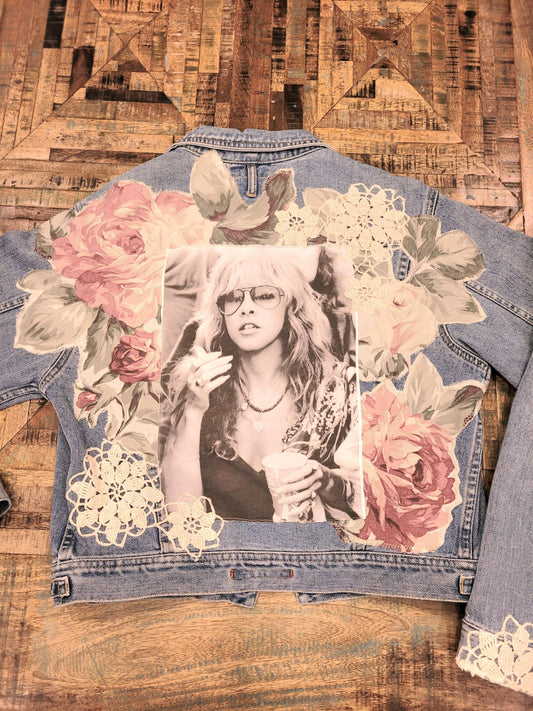 A denim jacket with a photo of a woman on it.