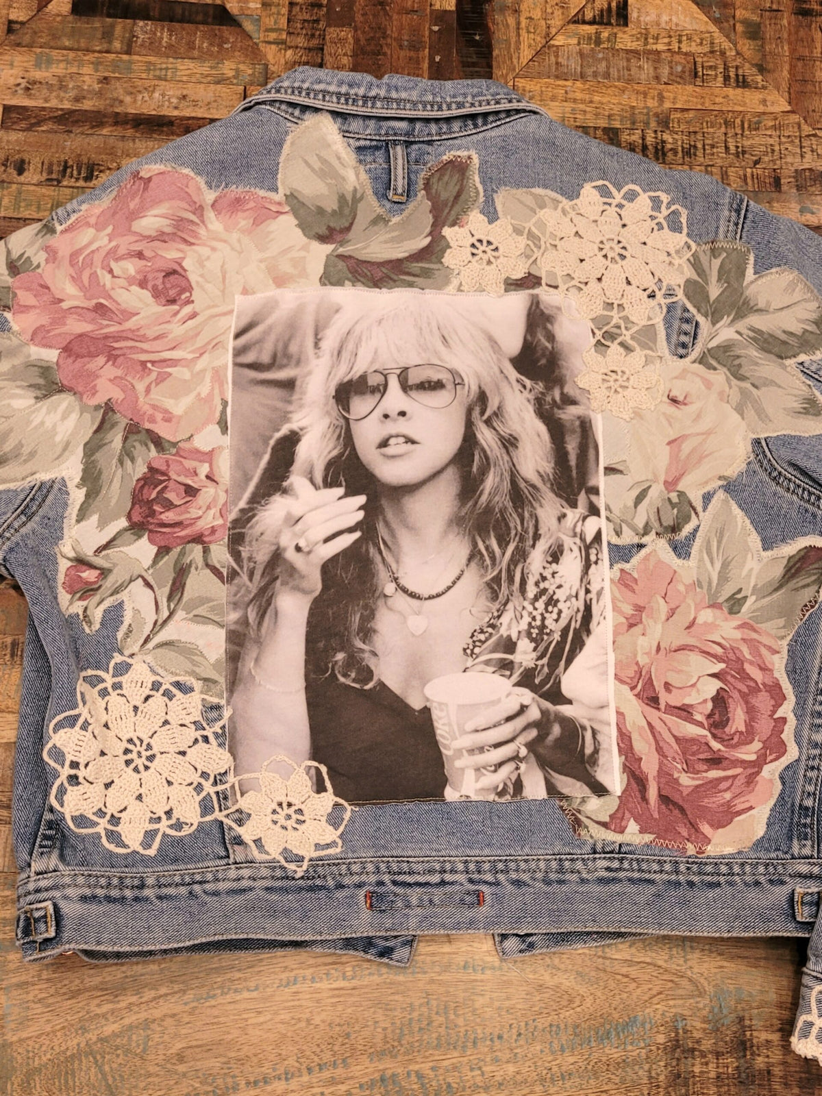 A denim jacket with a photo of a woman on it.