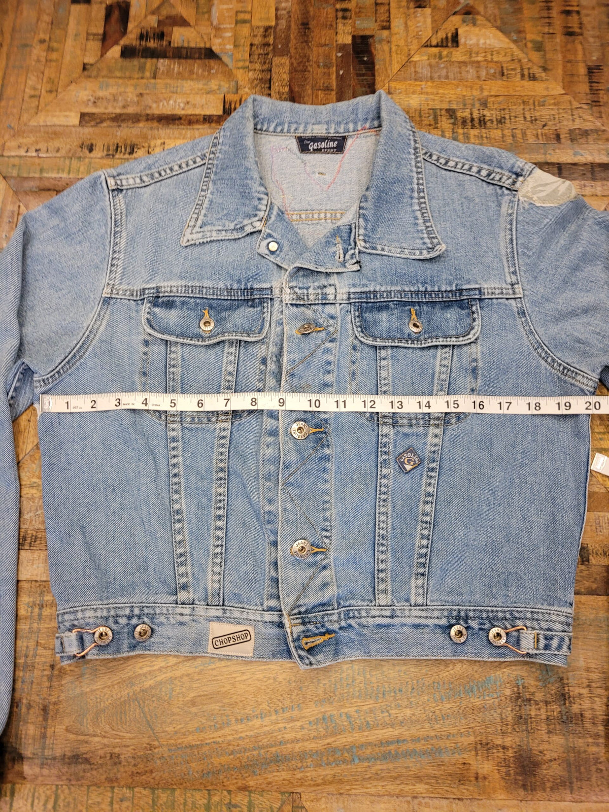 A denim jacket with a measuring tape on it.