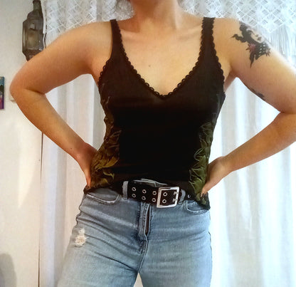 A woman wearing a black tank top and jeans.