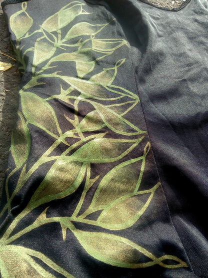 A black shirt with green leaves on it.