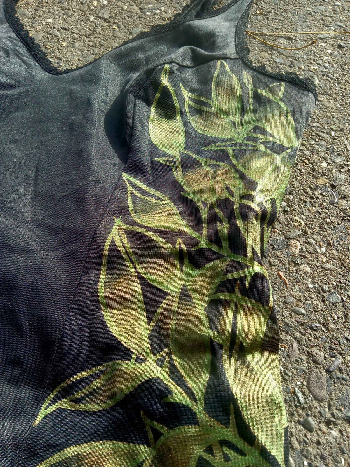 A black tank top laying on the ground.