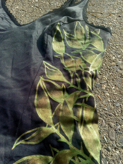 A black tank top laying on the ground.