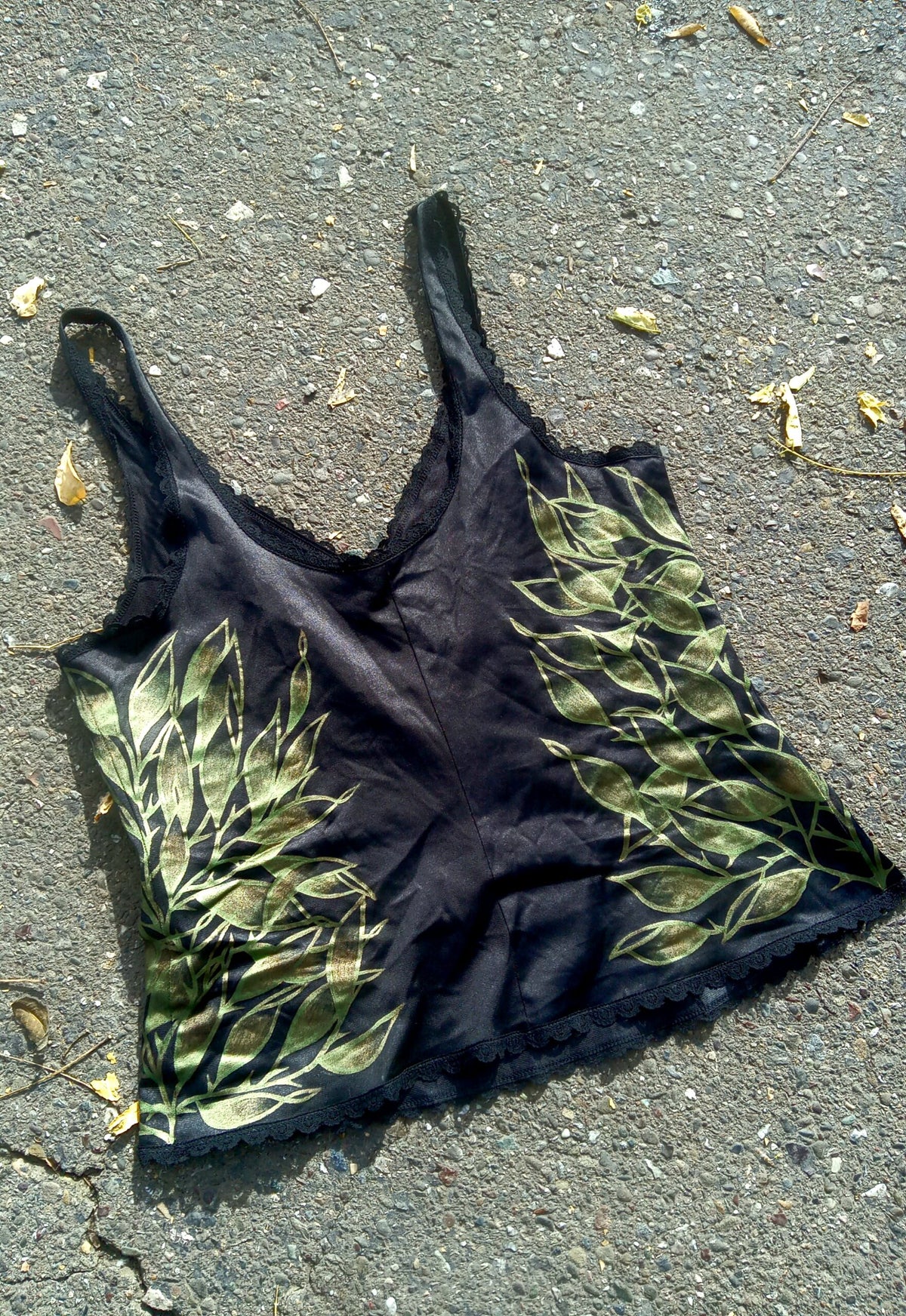 A black tank top laying on the ground.