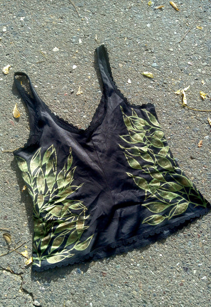 A black tank top laying on the ground.