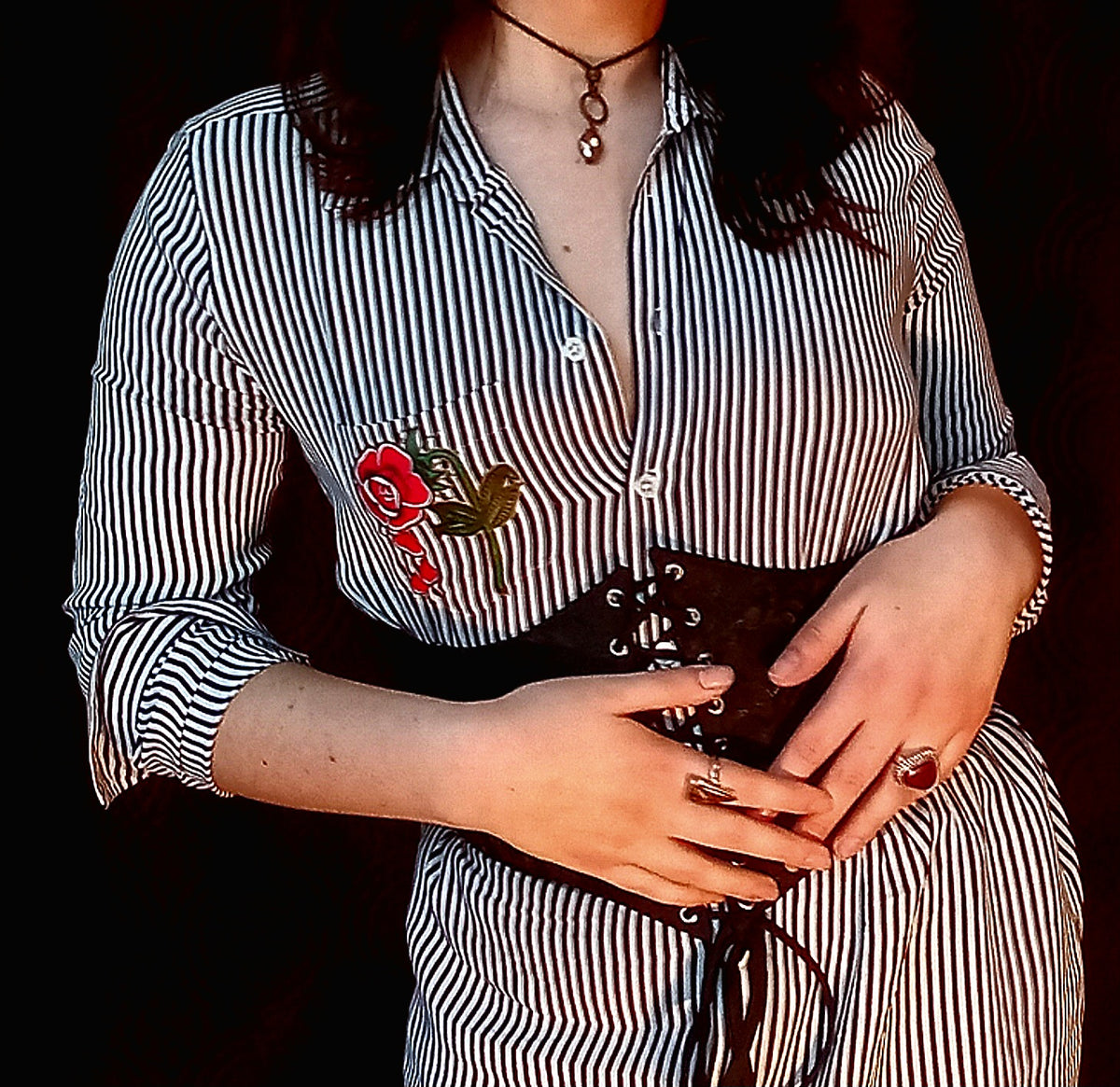 A woman wearing a black and white striped shirt.