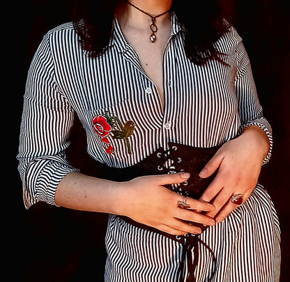 A woman wearing a black and white striped shirt.