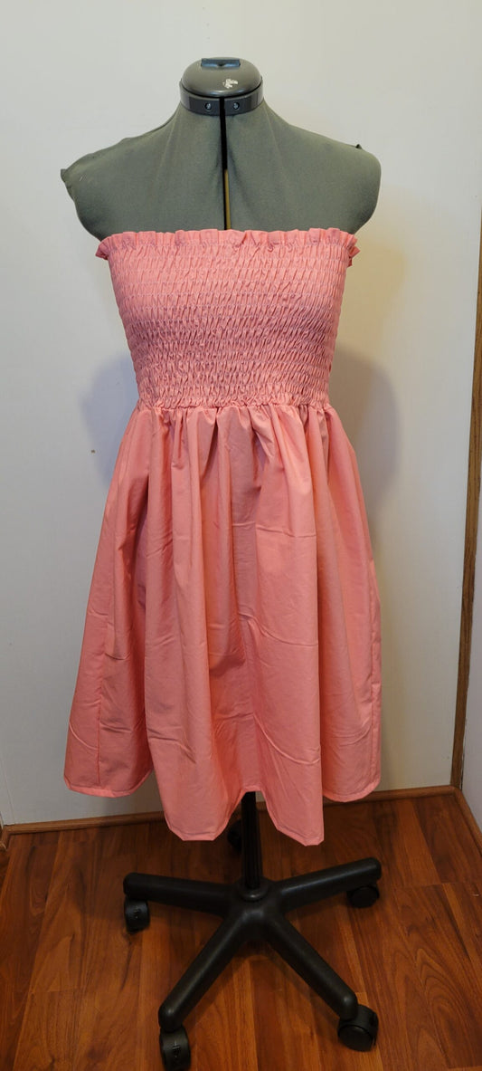 A pink dress on a mannequin.