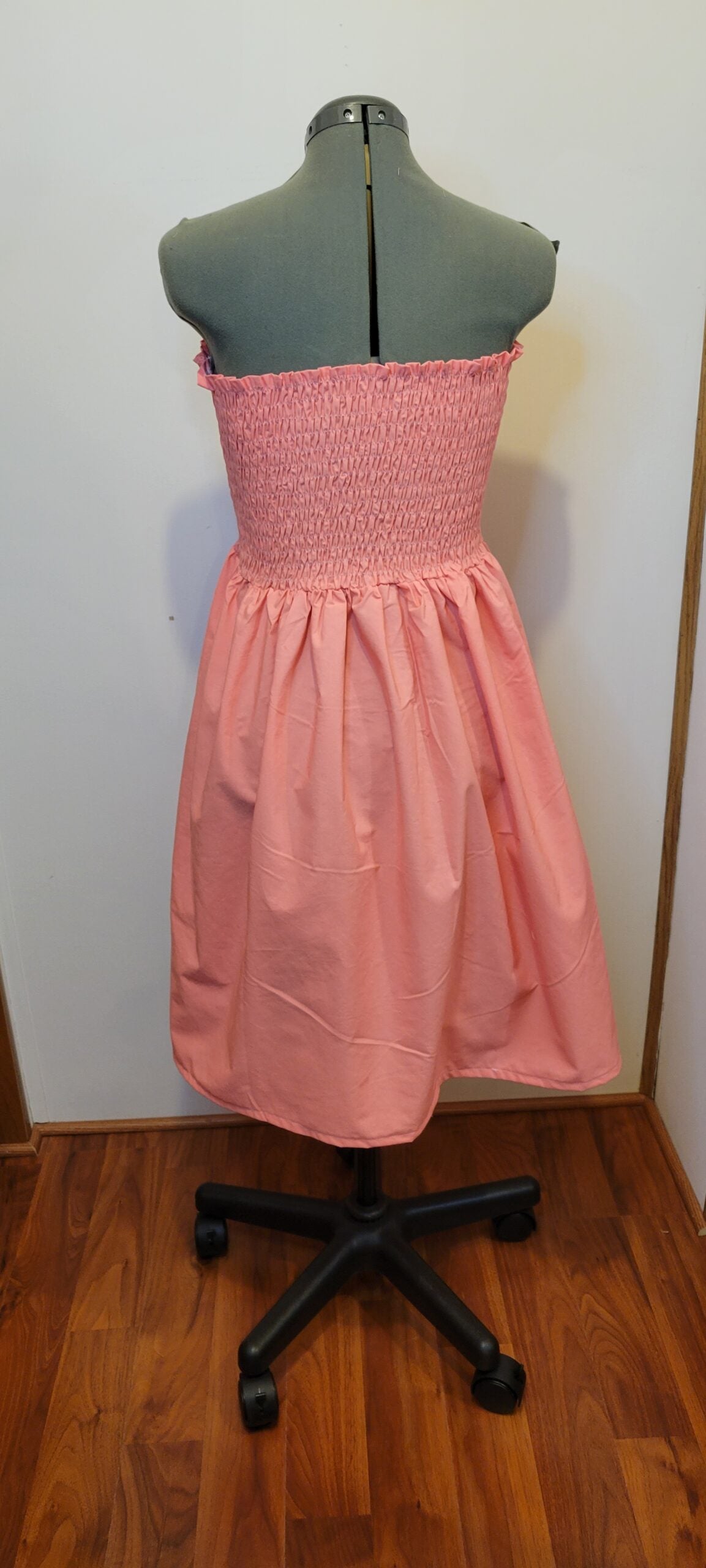 A pink dress on a mannequin.