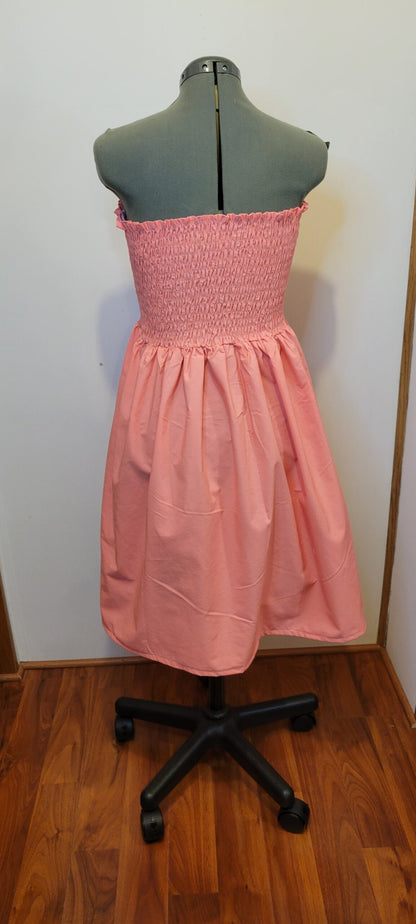 A pink dress on a mannequin.