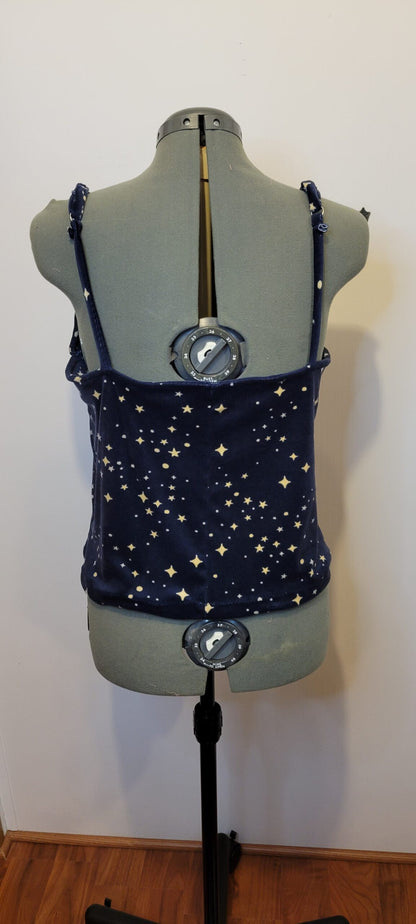 A mannequin with a tank top and compasses.