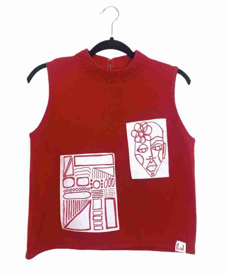 a red shirt with a drawing on it.