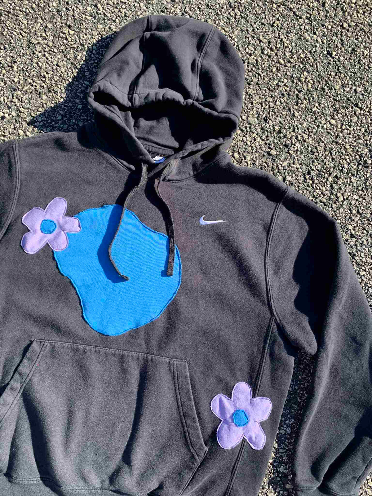 a gray hoodie with blue and purple flowers on it.