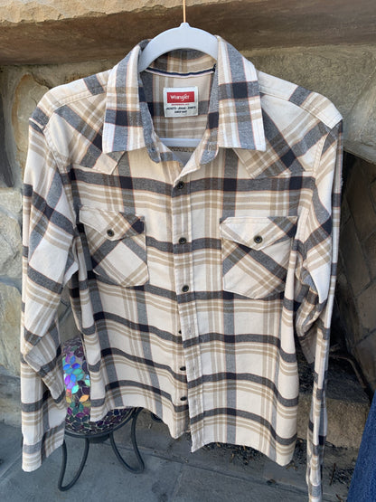 A Queen Music Rock Band Flannel Shirt hanging on a clothes rack.