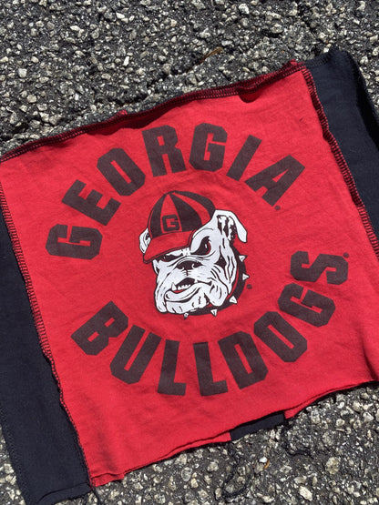 a red and black shirt laying on the ground.