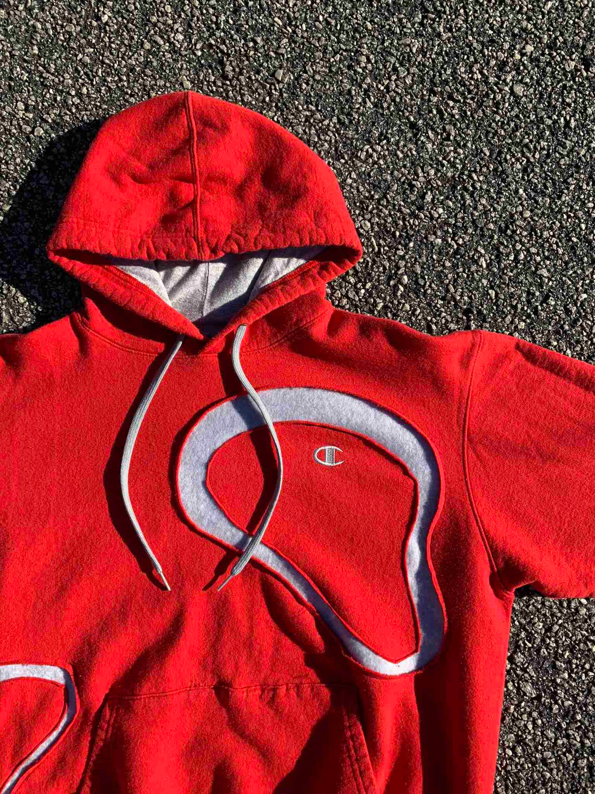 a red sweatshirt with a white logo on it.