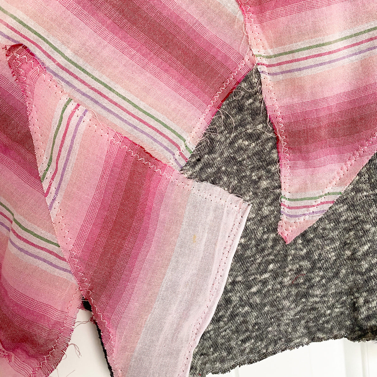 A pink and gray striped scarf on a table.