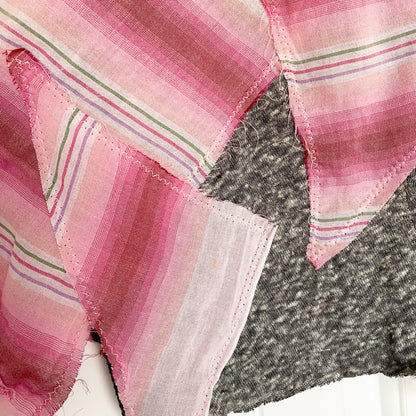 A pink and gray striped scarf on a table.