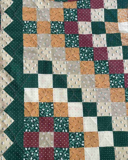 a close up of a quilt on a table.