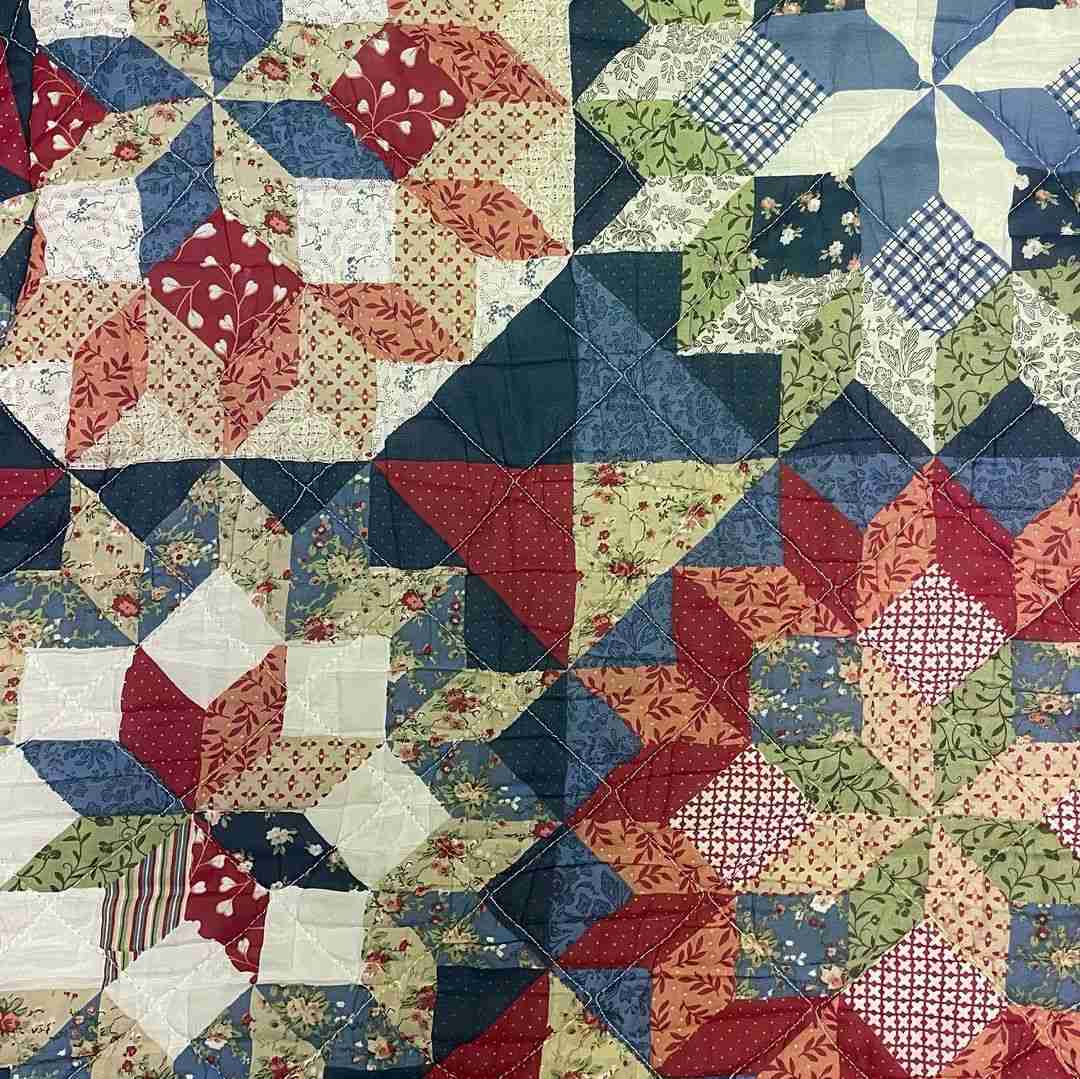 a close up of a quilt on a table.
