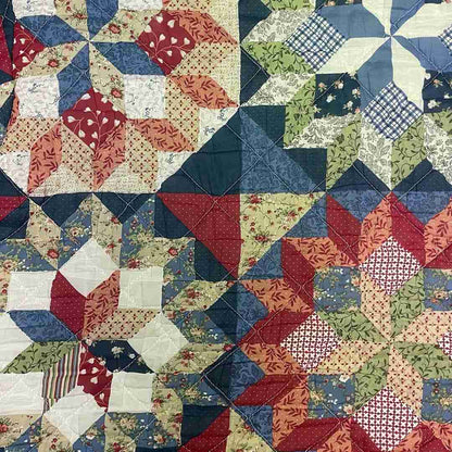 a close up of a quilt on a table.