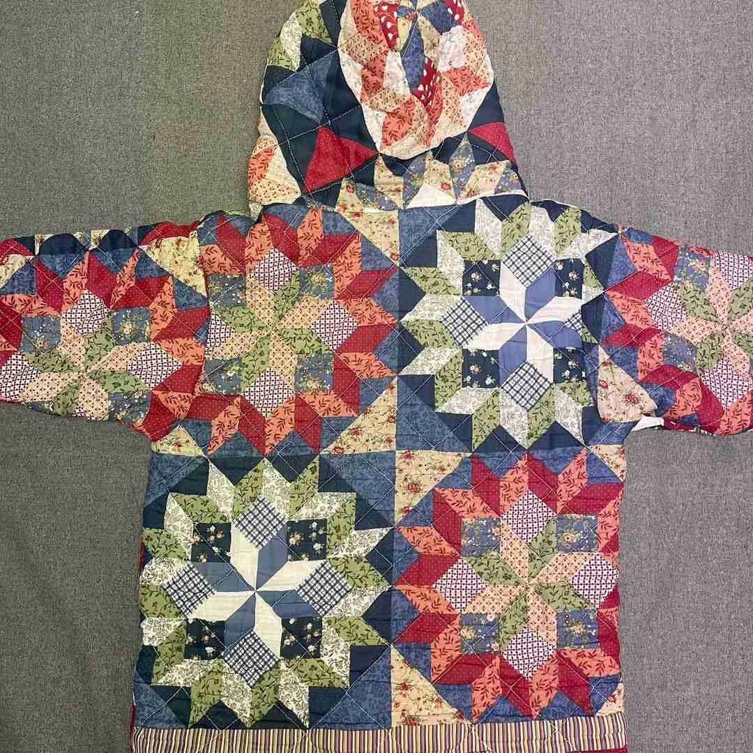 a quilted jacket with a hoodie on top of it.