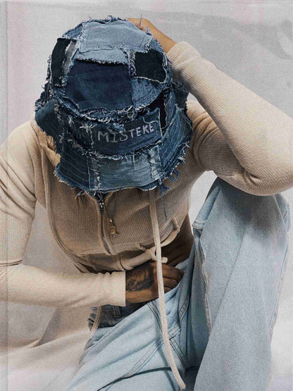 a person sitting down with a hat on their head.