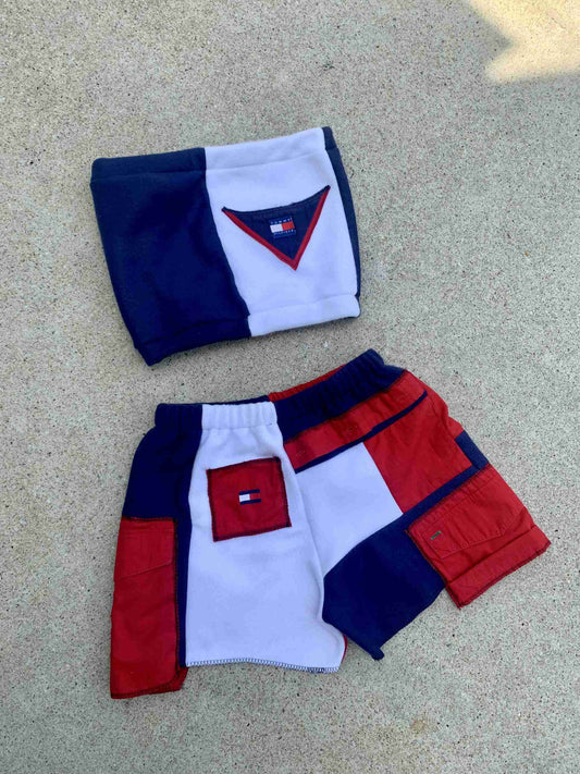 a pair of red, white, and blue shorts on the ground.