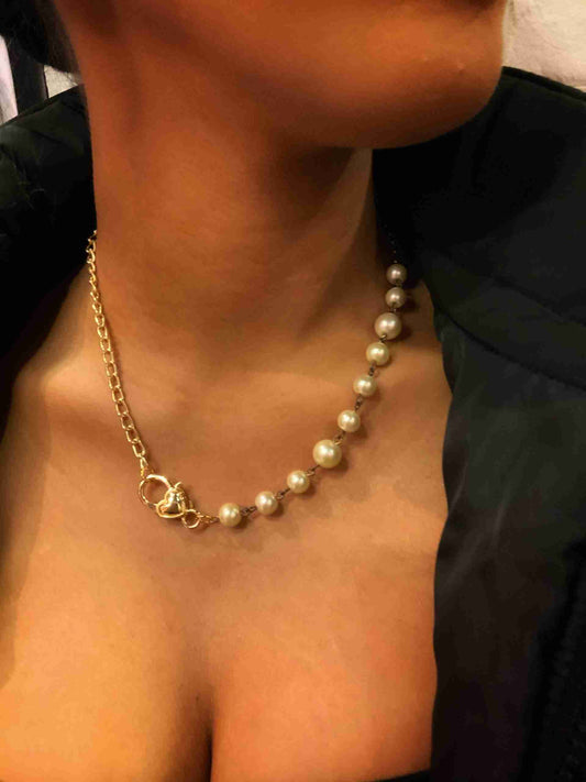 a close up of a person wearing a necklace.