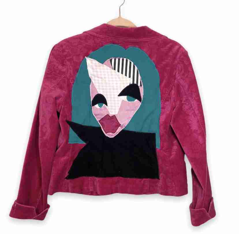 a pink jacket with an alien face on it.