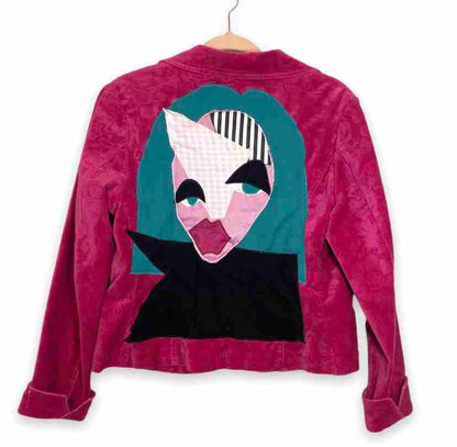 a pink jacket with an alien face on it.
