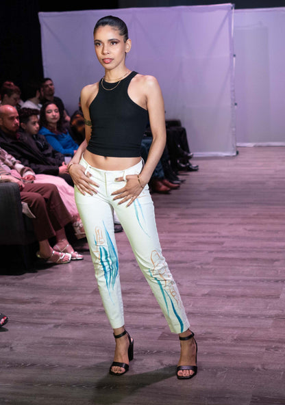 a woman standing on a runway in front of a crowd.