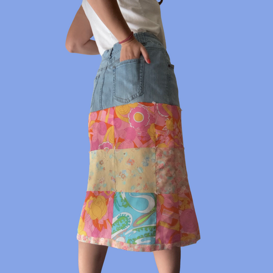 A woman wearing a colorful patchwork skirt.