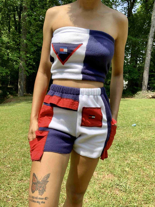 a woman in a blue and white top and shorts.