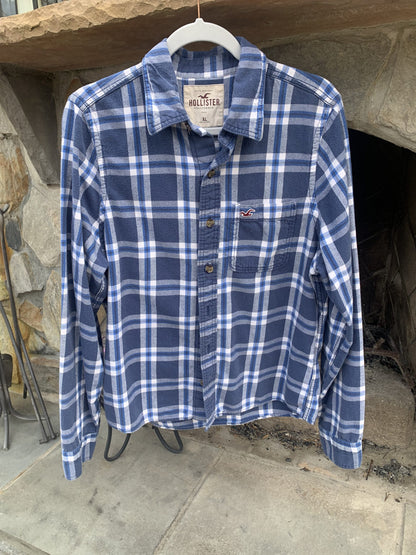A Pinball Wizard Rock Band Music flannel shirt hanging on a rack.