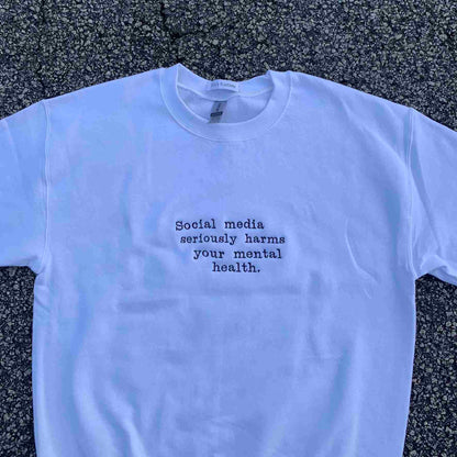 a white t - shirt that says social media seriously harms your mental health.