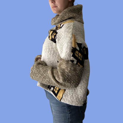 A woman wearing a sweater and jeans.