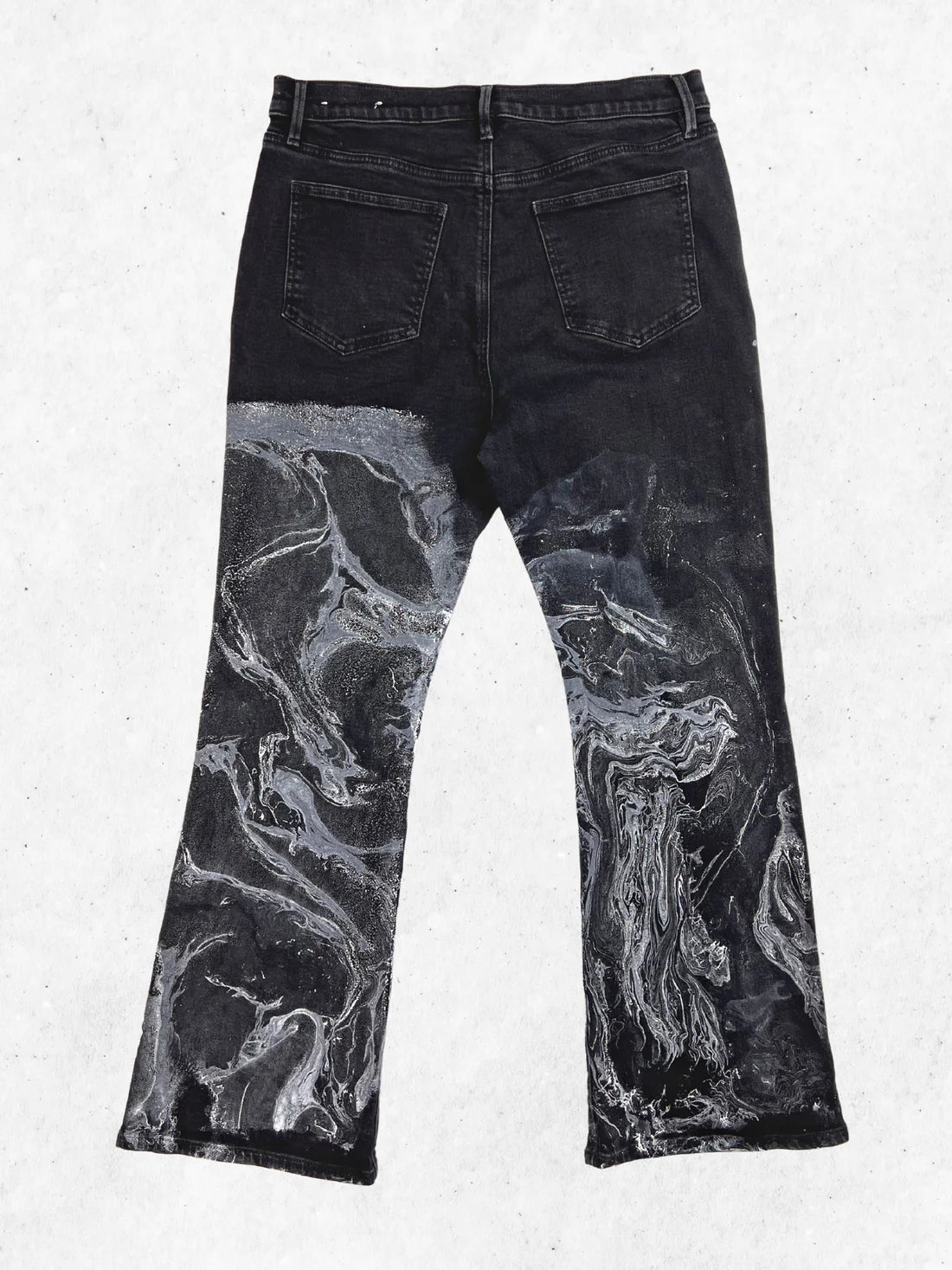 A pair of black jeans with a black and white print.