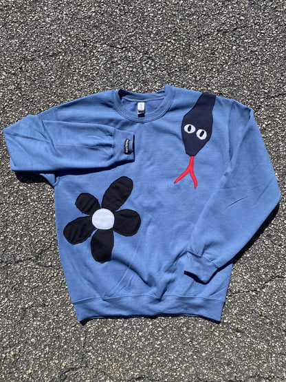 a blue sweatshirt with a black bird on it.