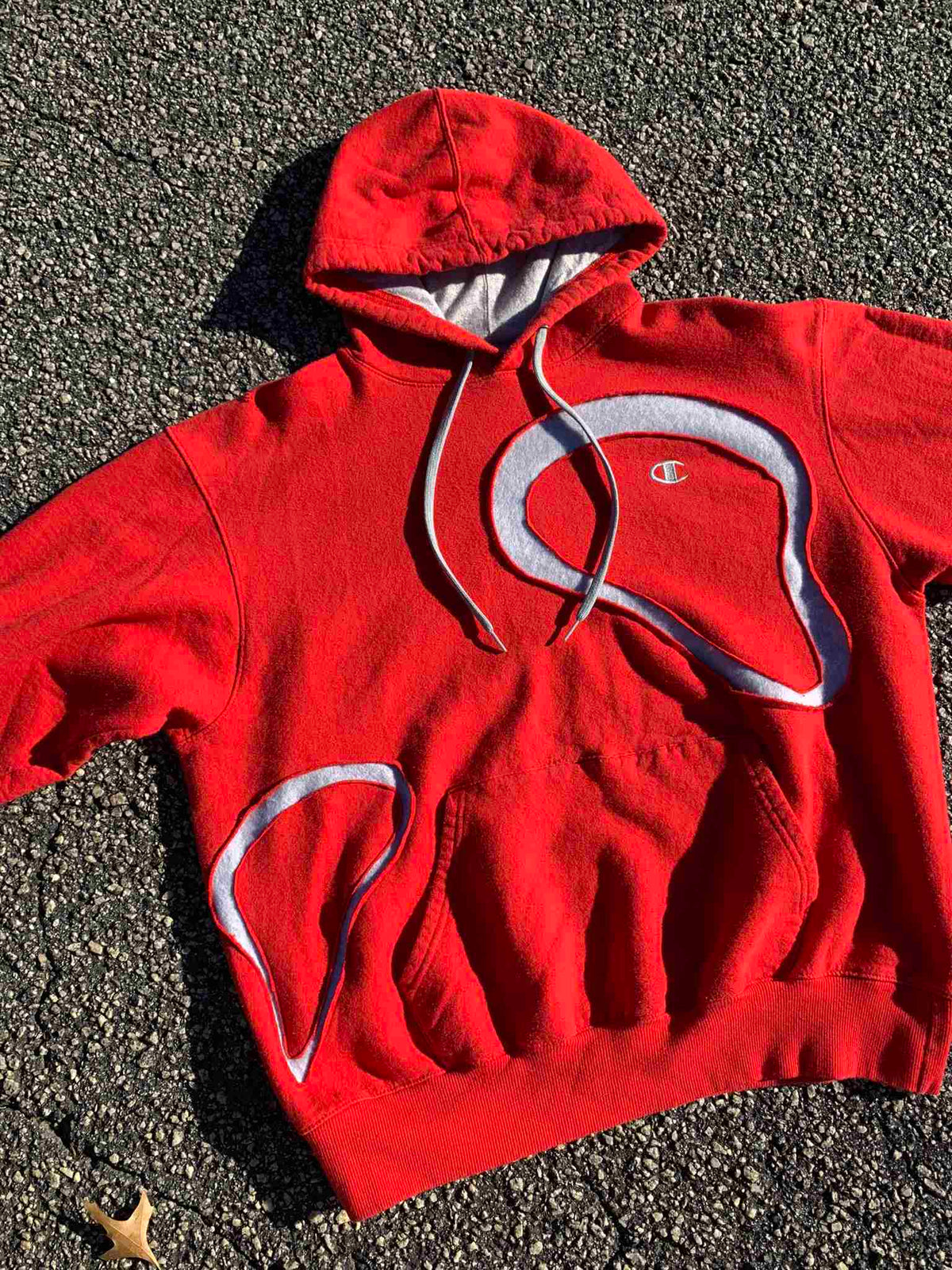 a red hoodie laying on the ground.