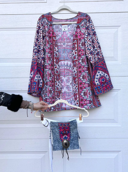 a woman's hand is holding a piece of clothing.