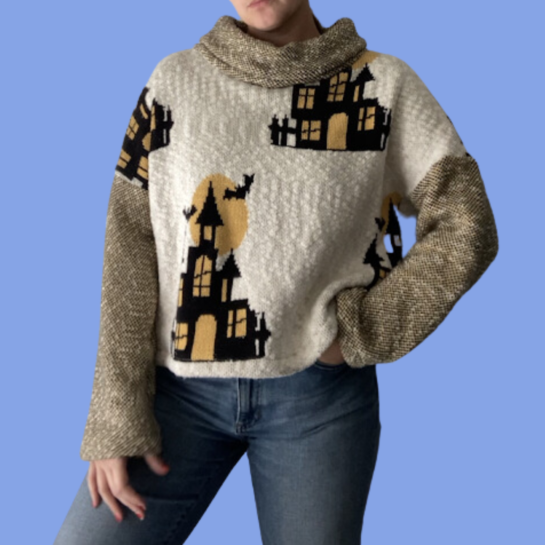 A woman wearing a sweater with houses on it.