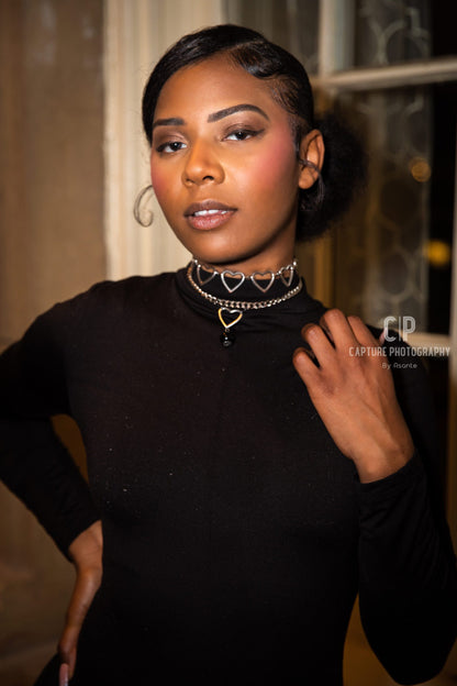 a woman in a black top is posing for a picture.