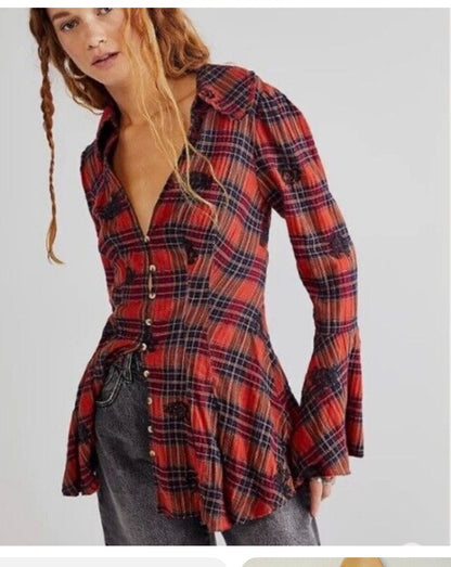 a woman is wearing a plaid shirt and jeans.