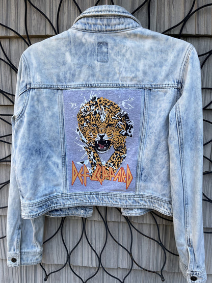 A denim jacket with an image of a cheetah on it.