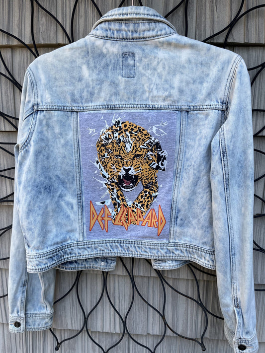 A denim jacket with an image of a cheetah on it.