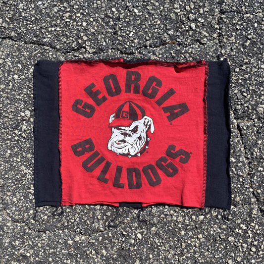 a red and black bandana laying on the ground.